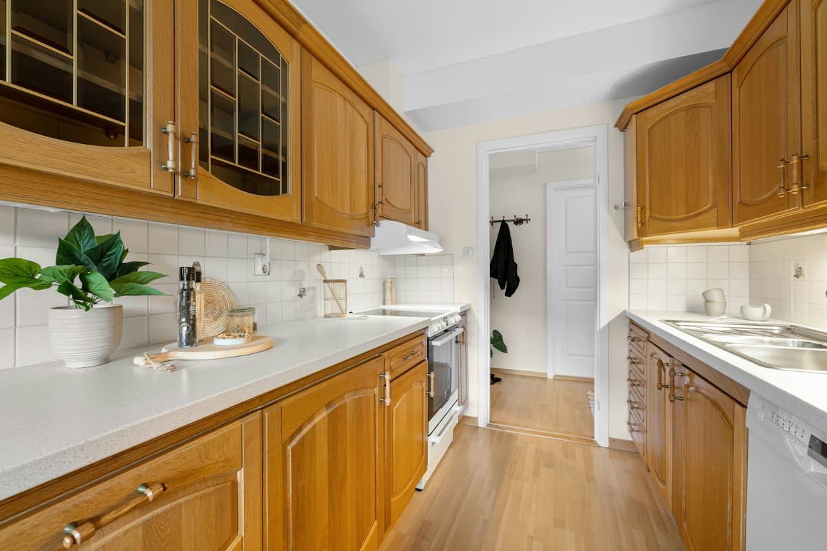 Kitchen with wooden cabinets and white countertops